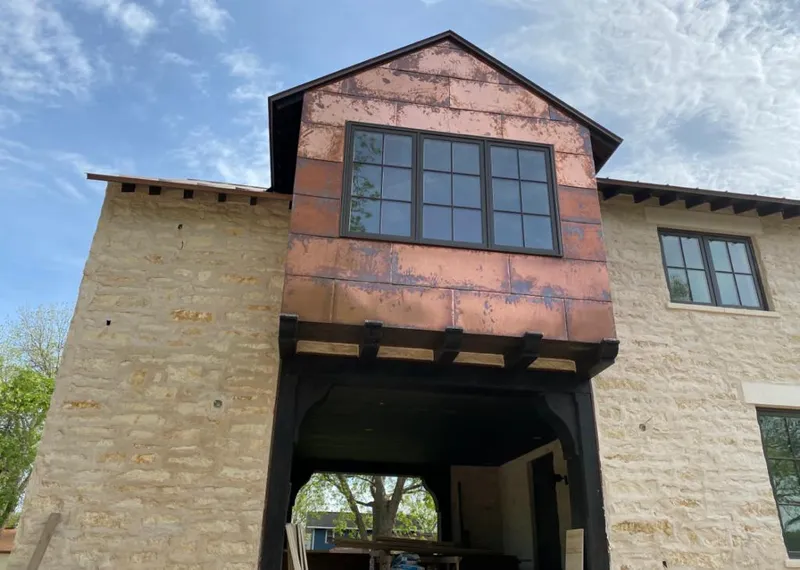 Copper metal panel facade on a stone building for Skylight Installation in Summerfield